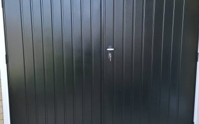Side hung garage door, on white steel frame.